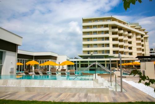 a hotel with a swimming pool in front of a building at Hotel Terme Abano Verdi in Abano Terme