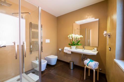 a bathroom with a toilet and a sink and a shower at Il Melograno Relais in Vico Equense