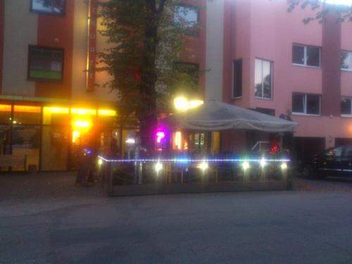 a gazebo with lights in front of a building at Ranna Sadama Villa in Pärnu