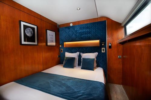 a small bedroom with a bed on a boat at VIP Paris Yacht Hôtel & Spa in Paris