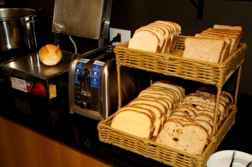 a group of baskets of bread on a counter at Pousada Du Valle in Embu