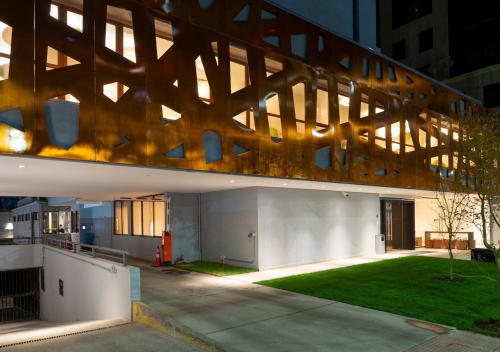 an external view of a building with a large wooden structure at 45 by Director in Santiago