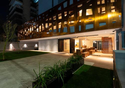 a large building with a courtyard at night at 45 by Director in Santiago