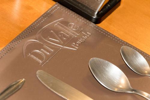 a metal plate with spoons on a table at Pousada Du Valle in Embu
