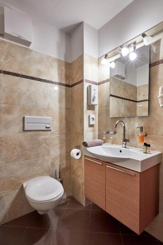 a bathroom with a toilet and a sink at Hotel Garni Savoy - new opening in Castelrotto
