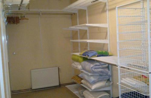 a closet with a bunch of towels on shelves at Figaro in Ventspils