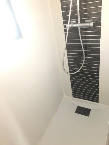 a bathroom with a shower with a black grate at Oléron in Saint-Denis-dʼOléron