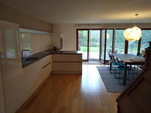 a kitchen with a table and a dining room at Wälderhus Tamegger in Krumbach