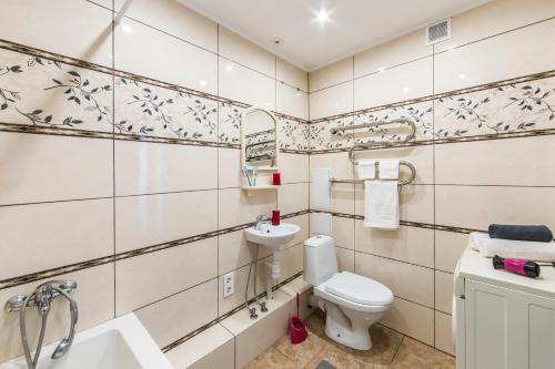 a bathroom with a toilet and a sink at Super view, luxury apartment near Chernihiv metro. in Kyiv