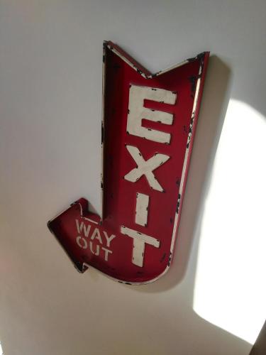 a sign on a wall that reads way cut at Le Grenier in Les Ageux