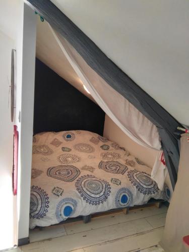 a bedroom with a bed in a tent at Le Grenier in Les Ageux