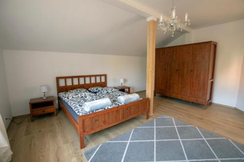 a bedroom with a bed and a chandelier at Józefina in Szczyrk