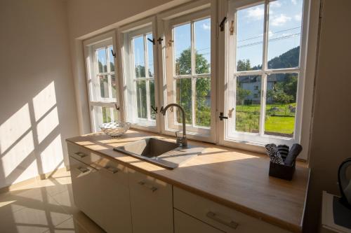 a kitchen with a sink and a large window at Józefina in Szczyrk