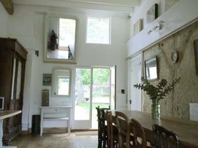 una sala da pranzo con tavolo e vaso di fiori di Lilac cottage a La Haye