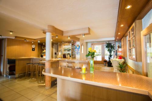 a large kitchen with a bar in a house at Gasthaus zum Holzwurm in Gransdorf