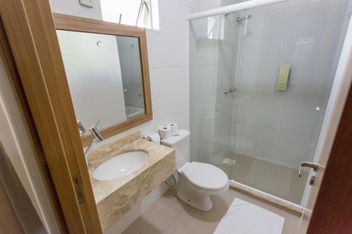 a bathroom with a sink and a toilet and a shower at Villa das Termas Hotel in Piratuba