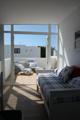 a bedroom with a bed and a large window at MariCel in Teguise