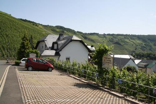 a red car parked in front of a house at Gästehaus Kirchlay in Kröv