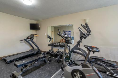 a gym with two exercise bikes in a room at Devonian Hotel and Suites in Fox Creek