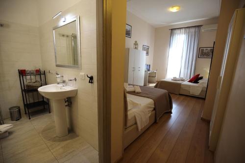un bagno con un lavandino e un letto in una stanza di Aria Rome Rooms a Roma