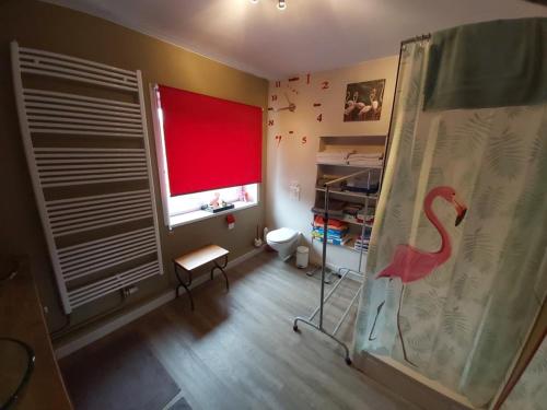 a room with a red window with a flamingo on the curtain at Nouvelles chambres très confortables avec réfrigérateur in Anhée