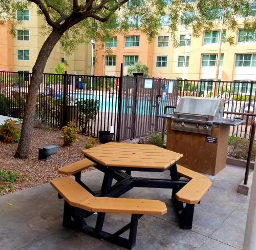 a picnic table with two benches and a grill at The Grandview at Las Vegas in Las Vegas