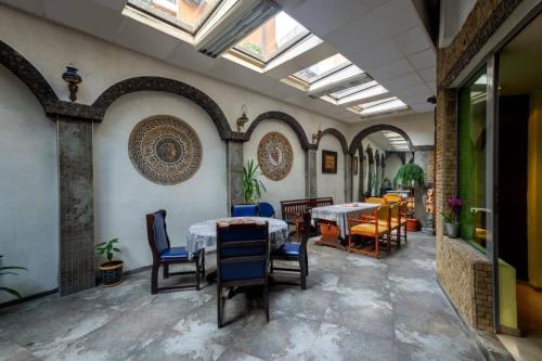 a dining room with two tables and chairs at Hotel Trakart Residence in Plovdiv