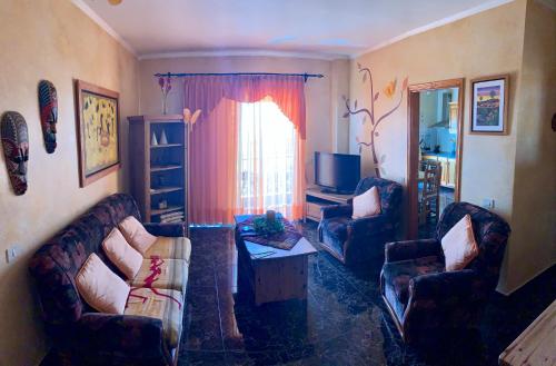 a living room with two couches and a television at Naomi’s House in Fasnia