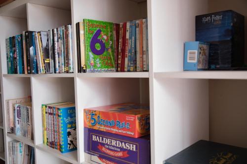 a book shelf filled with lots of books at BKs Palm Court Motor Lodge in Gisborne