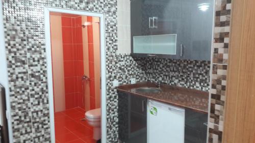 a bathroom with a sink and a toilet at Gunay Pansiyon Antalya in Antalya