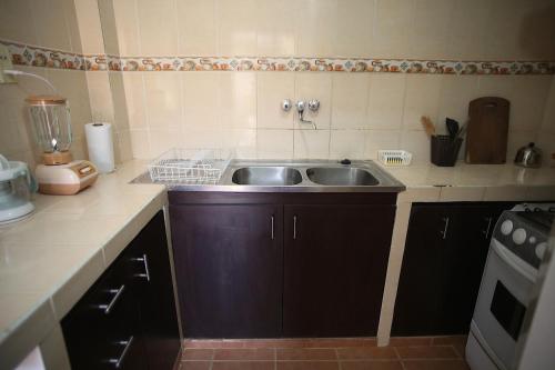 a kitchen with a sink and a counter top at Casa Los Jazmines in Sucre