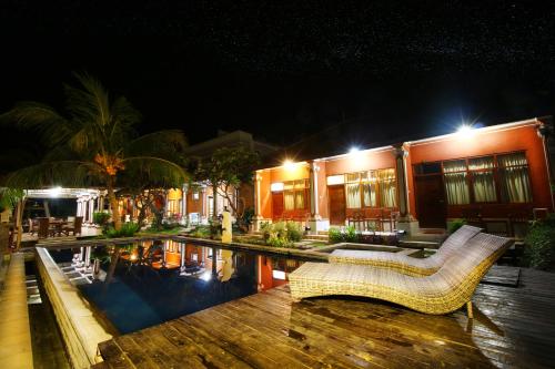 a resort with a swimming pool at night at Wahyu Dana Hotel in Lovina