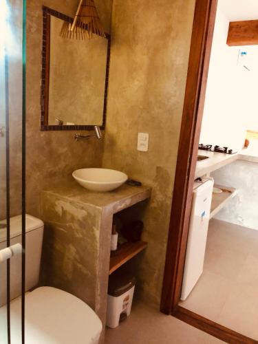 a bathroom with a sink and a toilet at Sina Residencial in Morro de São Paulo