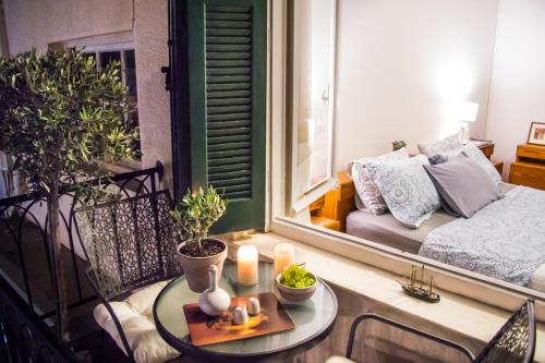 a small balcony with a table and a bed at Artistic Getaway Home - Super Central in Heraklio Town