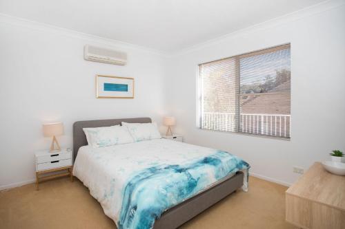 A bed or beds in a room at Beach side holiday apartment