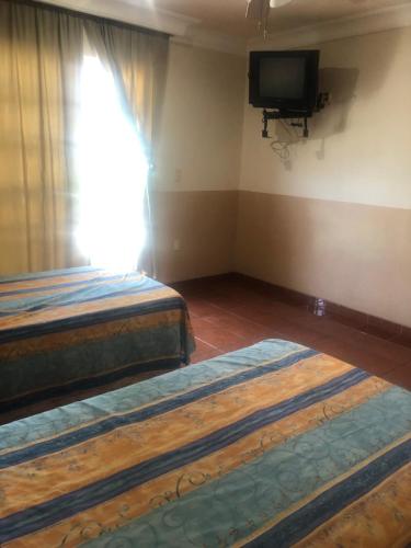 Ein Bett oder Betten in einem Zimmer der Unterkunft Hotel Playa María