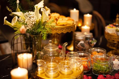 a table topped with candles and flowers and a centerpiece at Adora Art Hotel in Ho Chi Minh City