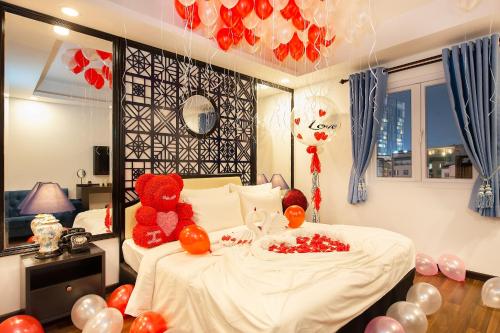 a bedroom with a bed with two teddy bears on it at Adora Art Hotel in Ho Chi Minh City
