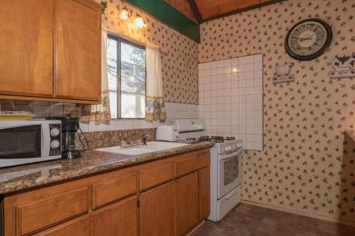 a kitchen with a sink and a stove at Black Forest Lodge in Big Bear Lake