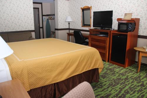 a hotel room with a bed and a tv at Spring House Inn in Porter