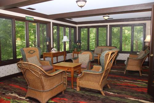 a lobby with chairs and tables and windows at Spring House Inn in Porter