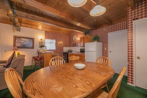 a kitchen and dining room with a wooden table and chairs at Black Forest Lodge in Big Bear Lake