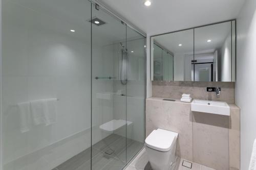 a bathroom with a toilet, sink, and shower at FV by Peppers in Brisbane