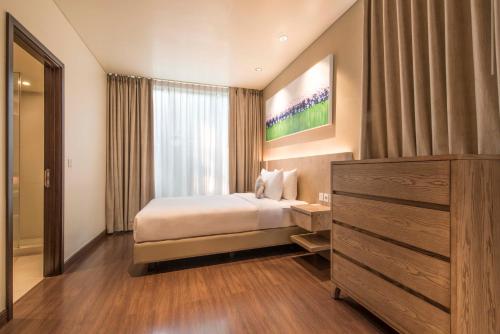 a bedroom with a bed and a large window at Dwijaya House of Pakubuwono in Jakarta