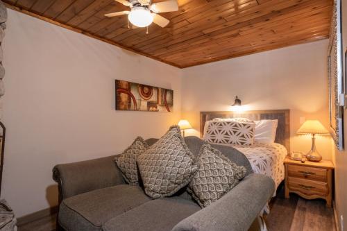 a bedroom with a bed and a couch in a room at Black Forest Lodge in Big Bear Lake