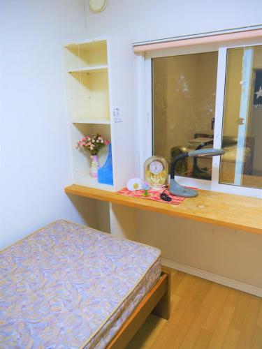 a room with a counter with a sink and a bench at Minpaku Mon in Sapporo