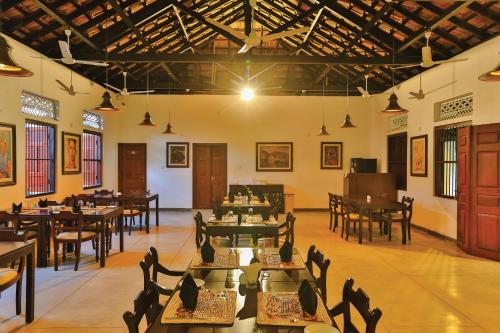 a restaurant with tables and chairs in a room at Fox Jaffna in Jaffna