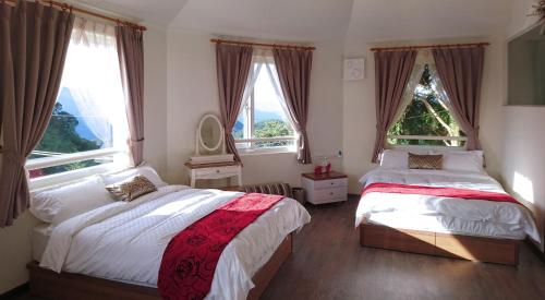 a bedroom with two beds and a christmas tree at SunSweet House in Fanlu