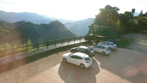 a group of three cars parked on top of a mountain at SunSweet House in Fanlu