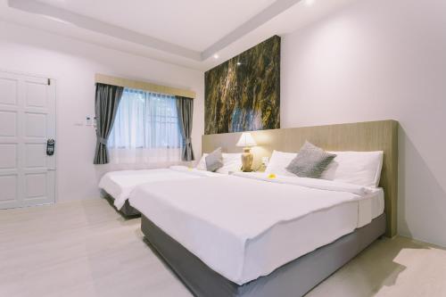 a large white bedroom with a large white bed at Fantasy Hill Bungalow in Kata Beach